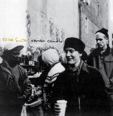 Album cover with black and white photo of people and text 'Elliot Smith Roman Candle'.
