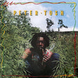 Album cover with a person smoking a cigarette surrounded by greenery and 'Peter Tosh' text.