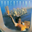 Album cover for 'Supertramp' featuring a person in an airplane with a cityscape in the background.