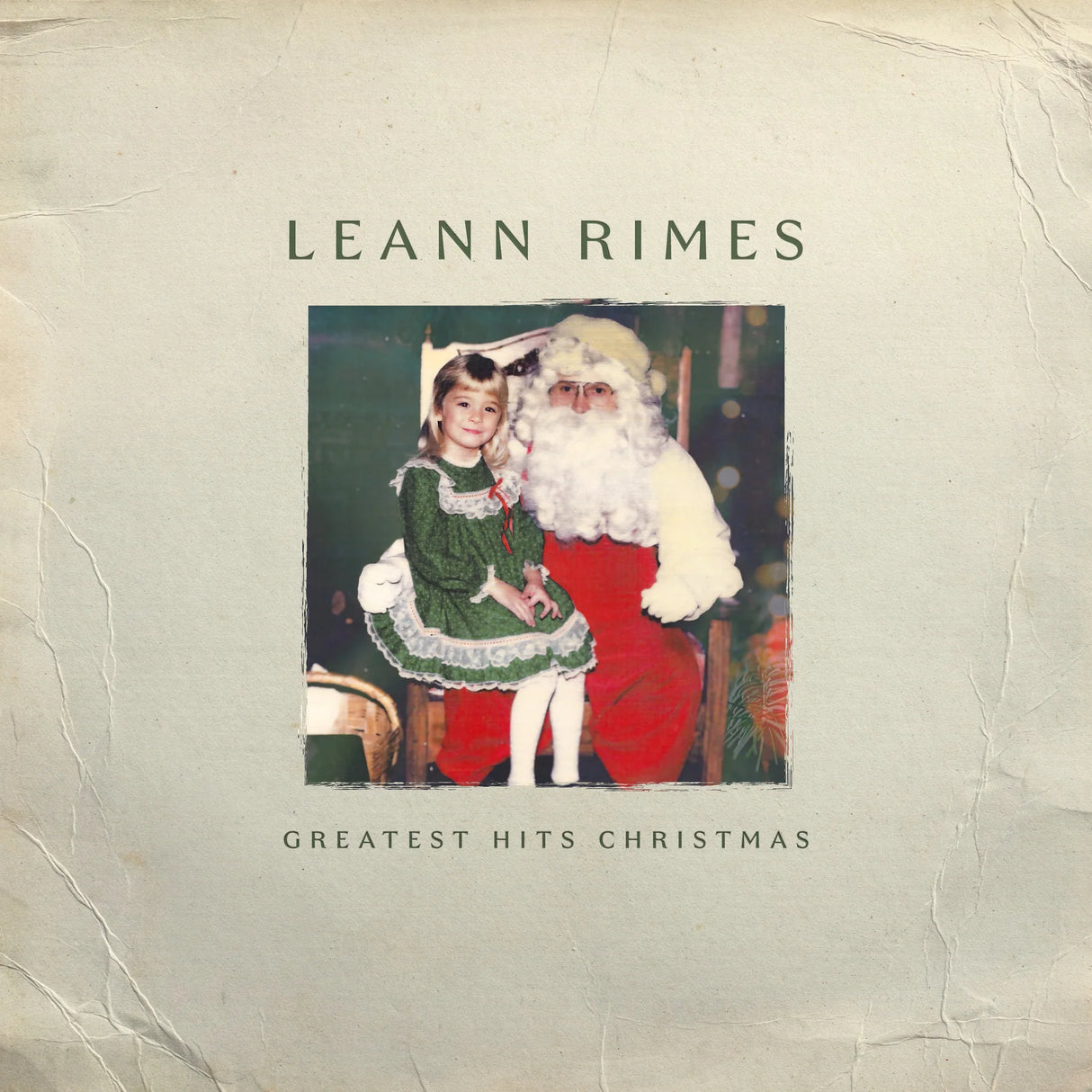 Album cover featuring a woman and Santa Claus with text 'Leann Rimes Greatest Hits Christmas' on a textured background.