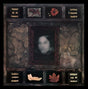 Decorative shelf with various items including a blurred face in the center