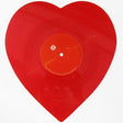 A red heart-shaped vinyl record.
