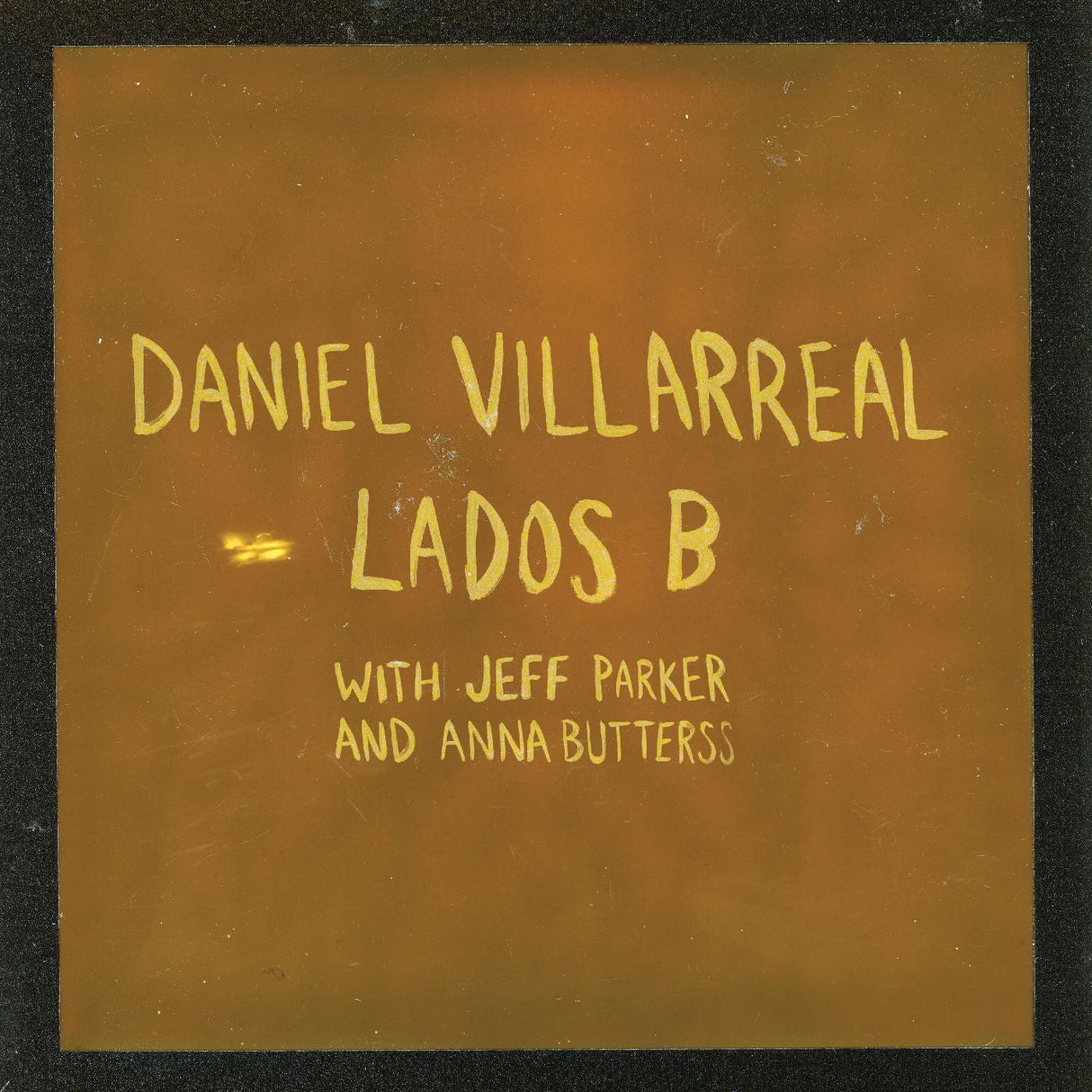 Album cover with text 'Daniel Villarreal - Lados B with Jeff Parker and Anna Butters' on a brown background