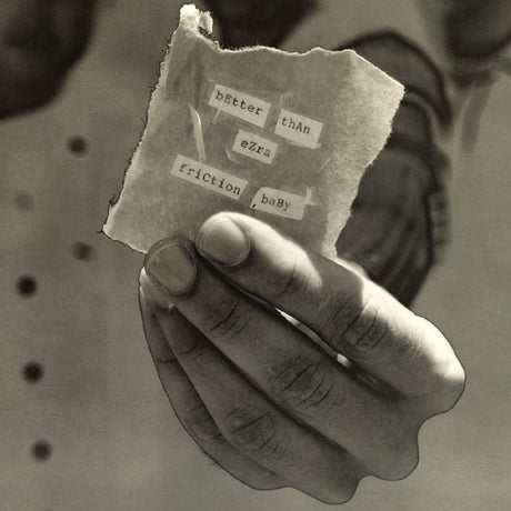 A hand holding a record album with 'BETTER THAN EZRA' and 'FRICCTION, BABY' written on it. The album is in a shattered condition with visible text and a shadow of a hand.