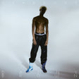 Album cover with a person wearing black pants and blue shoes on a light gray background
