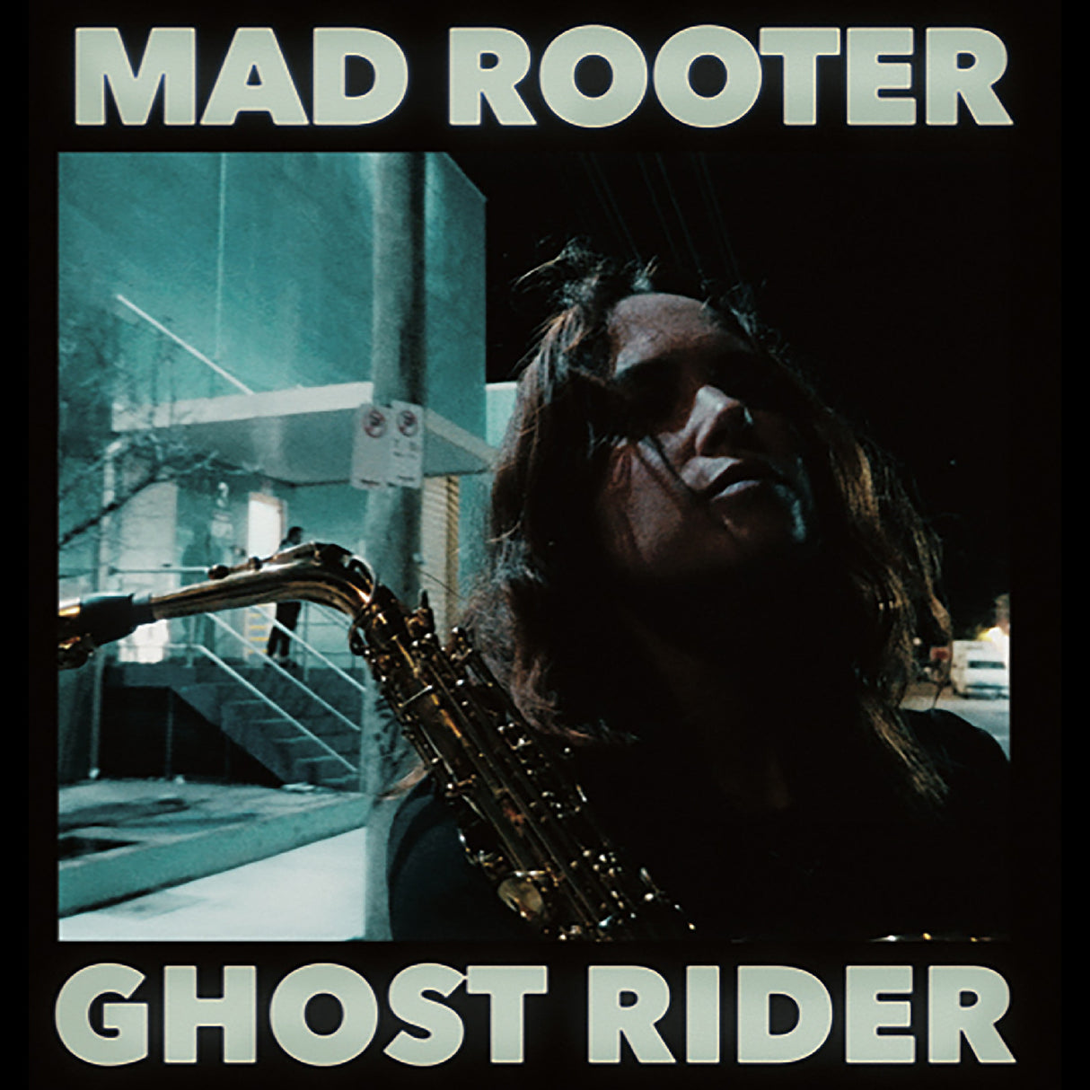 Album cover with a person holding a saxophone and text 'Mad Rooter Ghost Rider' in a stylized setting.
