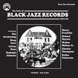 The front cover of the vinyl record 'The Best of Black Jazz Records 1971-76' by SJR Soul Jazz Records, featuring a black and white historical photograph of a large jazz ensemble in front of a house, with artist names listed on either side.