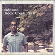 Person standing in a forest with 'Oddisee Rock Creek Park' text overlay