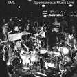 Black and white concert scene with musicians and audience in a dimly lit venue.