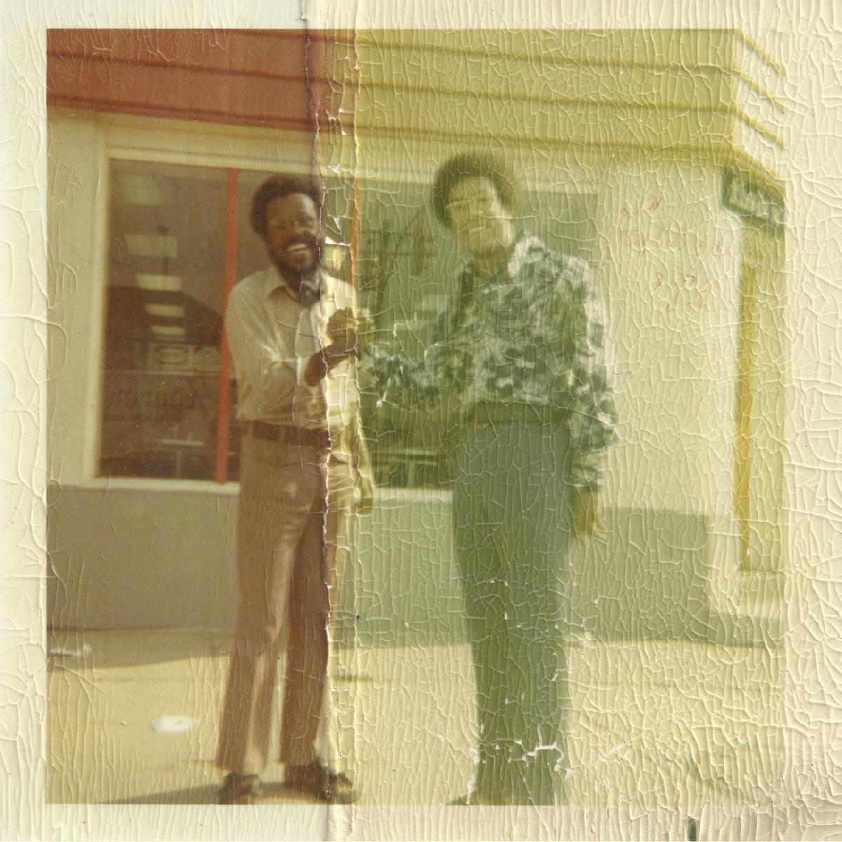 Two men standing outside a building with a textured overlay