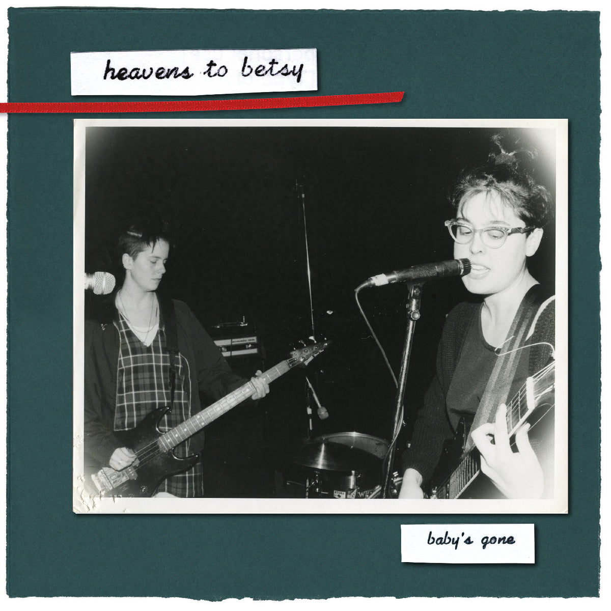 Album cover for 'heavens to betsy / baby's gone' featuring a black and white photo of two band members performing live, set against a dark teal background with white handwritten text labels.
