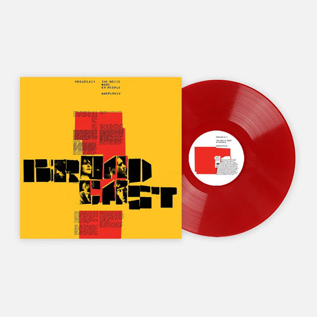 Red vinyl record with a yellow cover featuring text and graphics on a white background