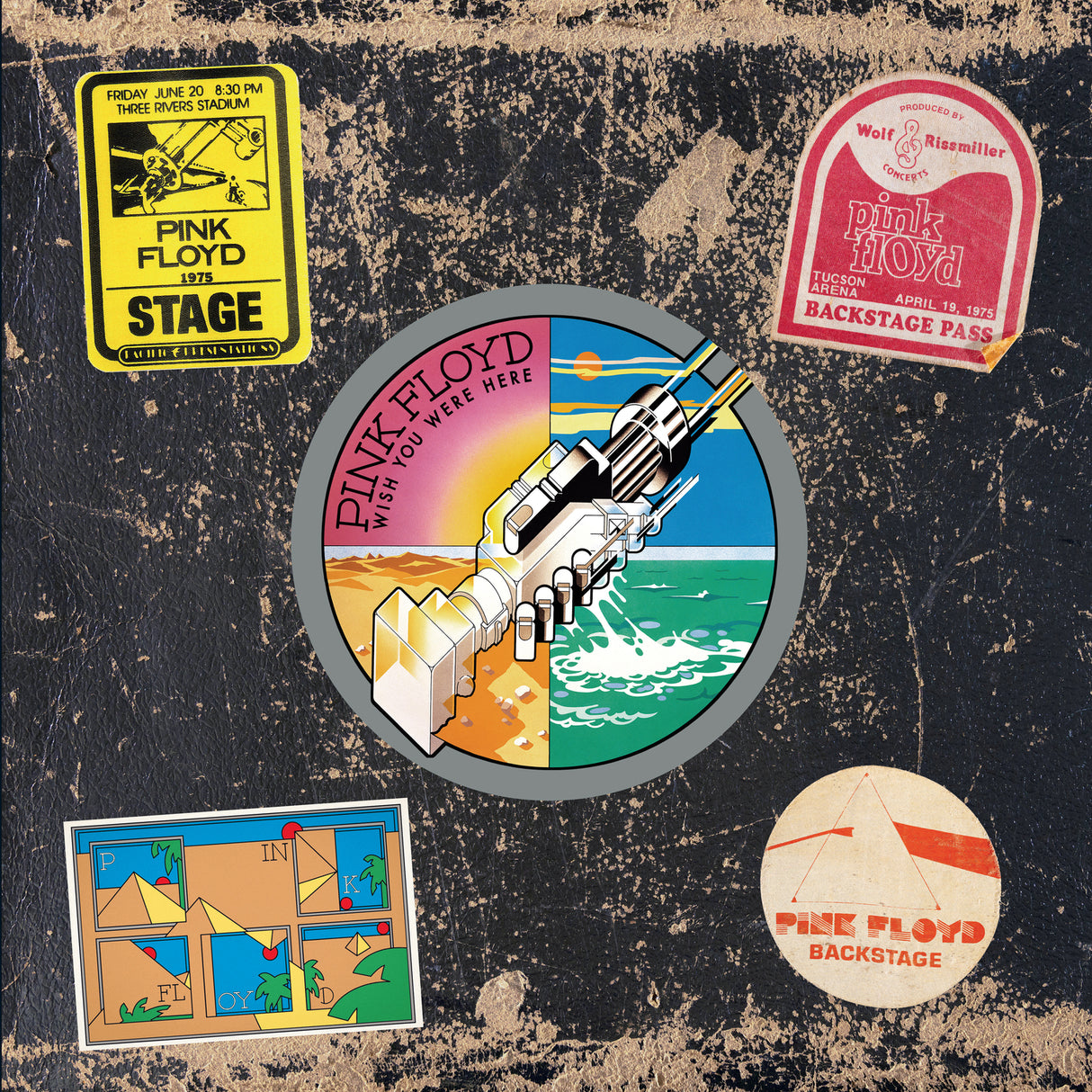 Pink Floyd album cover with various stickers and graphics on a textured black background