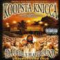 CD cover art for Koopsta Knicca's album 'Da Devil's Playground' featuring a man in a gold jacket posing with one hand extended, against an orange and yellow background with text and branding.