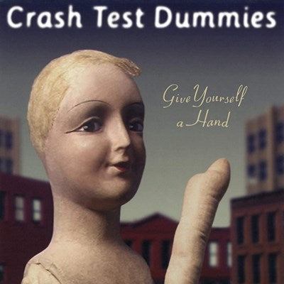 Album cover with a figure holding a thumb up against a cityscape background, featuring the text 'Crash Test Dummies Give Yourself a Hand'.