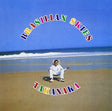 Person sitting on a beach with 'Brasillian Skies Takanaka' text overlay
