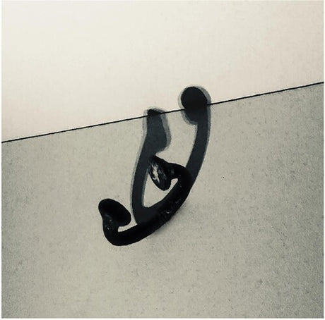 Black metal hook on a textured white surface
