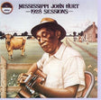 Record cover art featuring a man in a hat playing a guitar, with a background of a field and cows in the distance, indicating the 1928 sessions by Mississippi John Hurt.