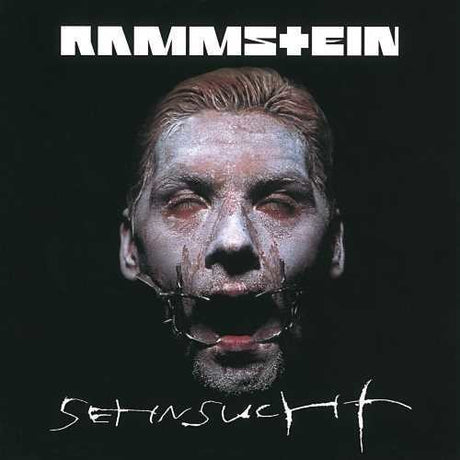 Album cover for Rammstein's 'Set It Off' with a person with white makeup and black face paint.
