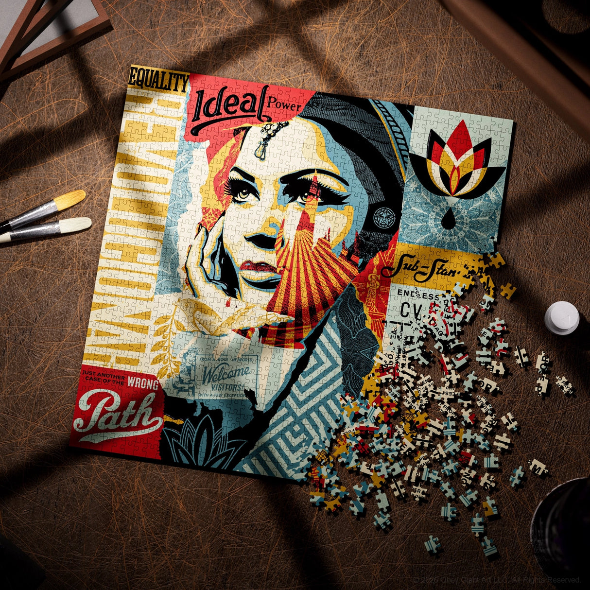 A completed and partially disassembled jigsaw puzzle featuring a stylized portrait collage with text elements like 'Equality', 'Ideal Power', and 'Path', displayed on a brown textured tabletop with scattered puzzle pieces around it.