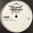 A close-up of a vinyl record label for the release 'L/Nº13' by Limited Network, featuring black text and graphic artwork on a white circular label, photographed against a dark background.
