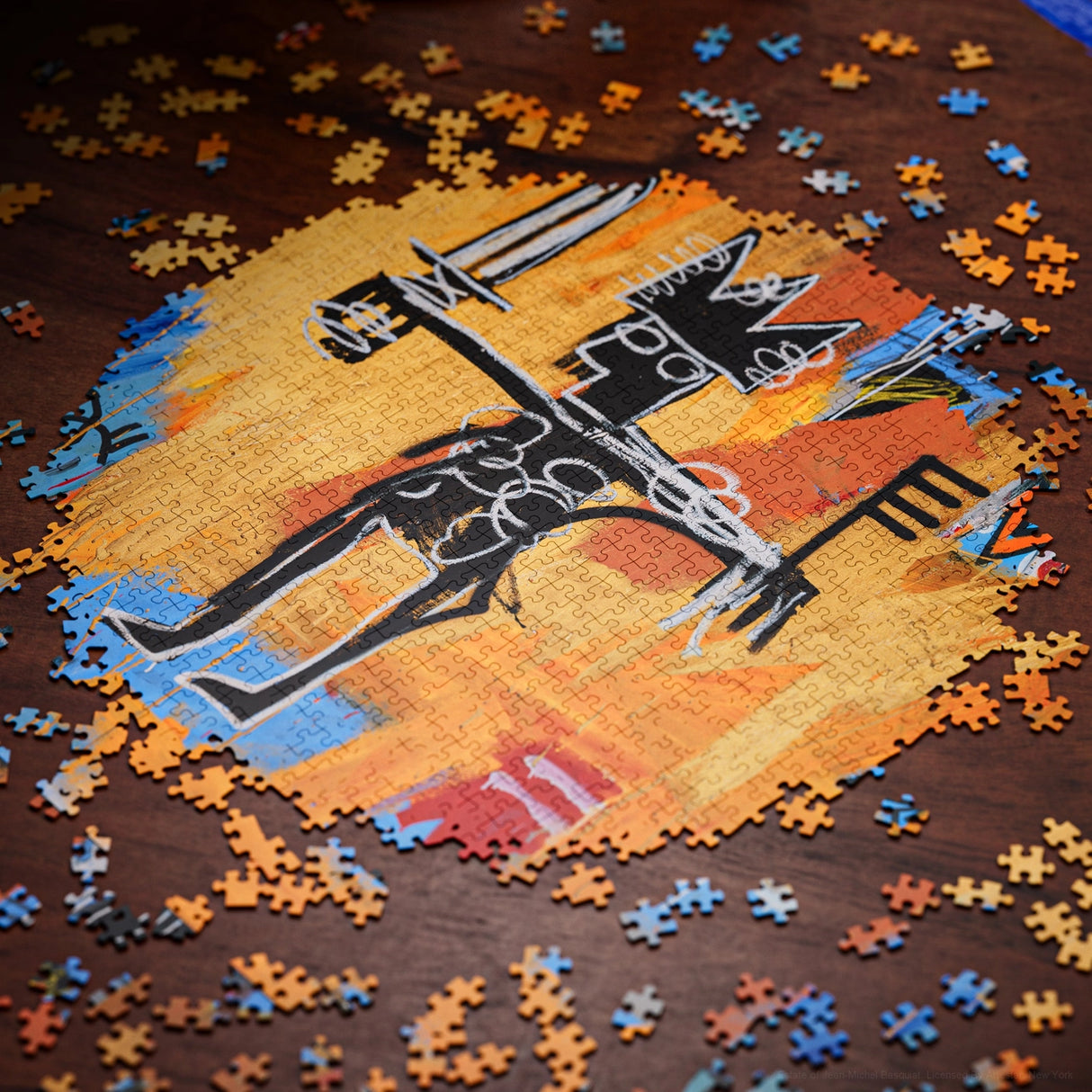 Jigsaw puzzle with a partially completed design of a skeleton and castle on an orange background.