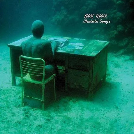 Person sitting at a desk underwater with 'Eddie Vedder Ukulele Songs' text.