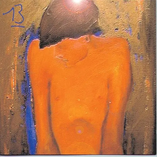 This image features the cover art for the Blur album "13," which is presented on a 2LP record. The artwork is enigmatic and abstract, utilizing a muted palette of oranges and blues that gives it a subtly vibrant feel.