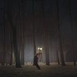 Person with glowing eyes in a dark forest