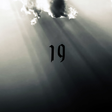 Number 19 in black on a foggy background with light rays穿透ing