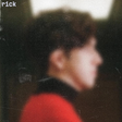 Blurred profile of a person wearing a red garment with 'rick' text at the top.