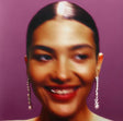 Close-up of a person with a purple background