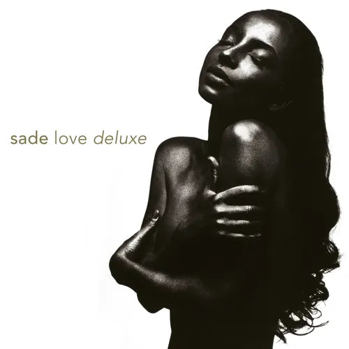 Black and white album cover featuring a photograph of Sade Adu, the lead singer of the band Sade, in an embracing pose.