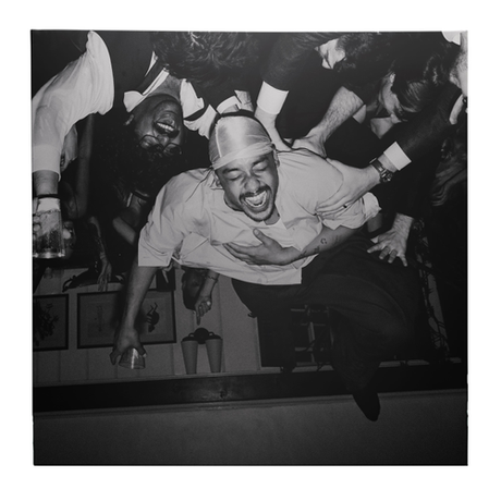 Black and white photo of a man in a crowd at a party