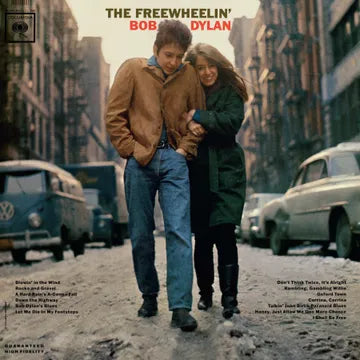 Album cover with two people walking on a street, surrounded by vintage cars.