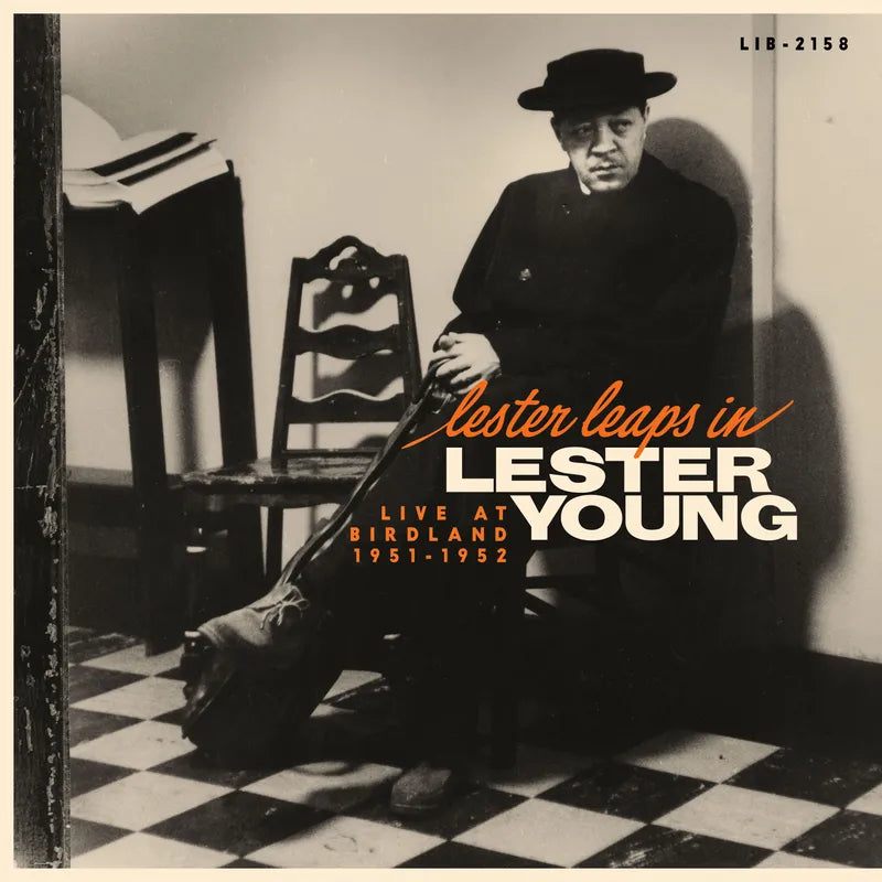 Album cover featuring a black and white photo of a man sitting on a checkered floor with text overlay.