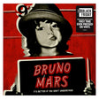 Vinyl record cover with a person holding a sign displaying 'Bruno Mars' on a red background.