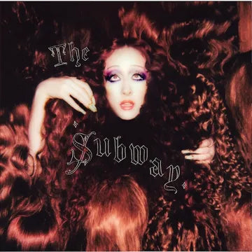 Album cover with a person in a fur coat and text 'The Subway' on a dark background