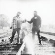 Two people shaking hands on a railway track with a blurred effect