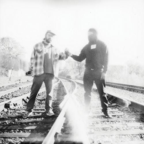 Two people shaking hands on a railway track with a blurred effect