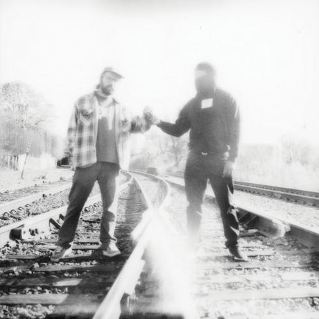 Two people shaking hands on a railway track with a blurred effect