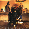 Album cover for Tallulah's 'Go-Betweens', featuring five band members posed in a warmly lit, rustic room with the title 'Go-Betweens' at the top and 'TALLULAH' at the bottom.