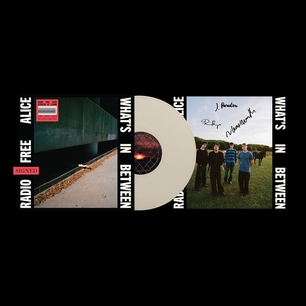 Radio Free Alice - What's In Between vinyl record album cover, featuring a cream-colored translucent vinyl disc with a red center label, flanked by the album artwork on a black background.