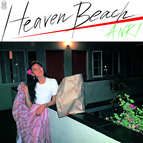A vinyl record titled 'Heaven Beach' by Anri with a visual representation of a woman standing on a balcony at night, holding a flower, with the album title and artist name in stylized text.