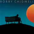 Album cover featuring a silhouette of a person sitting on a bench with a large sun in the background.