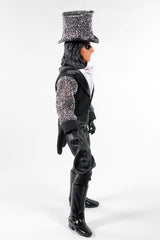 Person wearing a black outfit with glittery accents on a white background