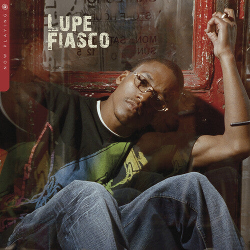 The cover image shows the artist, Lupe Fiasco, in a relaxed pose with his hands in his pockets, wearing eyeglasses and a casual shirt, against a backdrop of a red-lit room with graffiti.