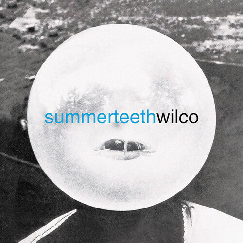 A vinyl record label with the text 'SUMMERTEETH WILCO' in blue font, against an image of a mouth-like opening with a blurred background.