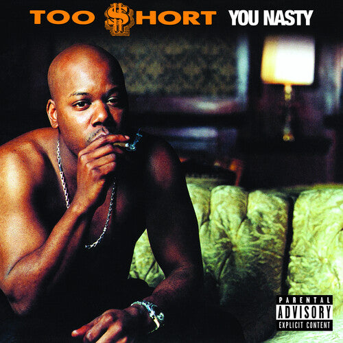 Album cover of Too $hort - You Nasty, featuring a man with a chain around his neck, sitting on a couch with a cigarette in his mouth.