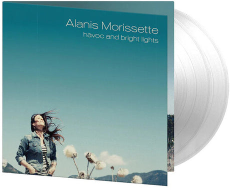 Vinyl record with 'Alanis Morissette' album cover showing a person with long hair against a blue sky.
